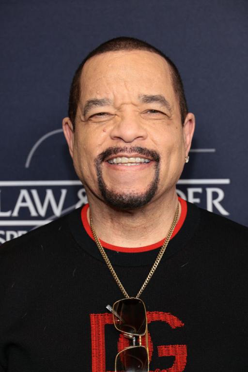 Ice-T attends the "Law & Order: Special Victims Unit" 25th Anniversary Celebration smiling wearing a Dolce & Gabanna black and red shirt.