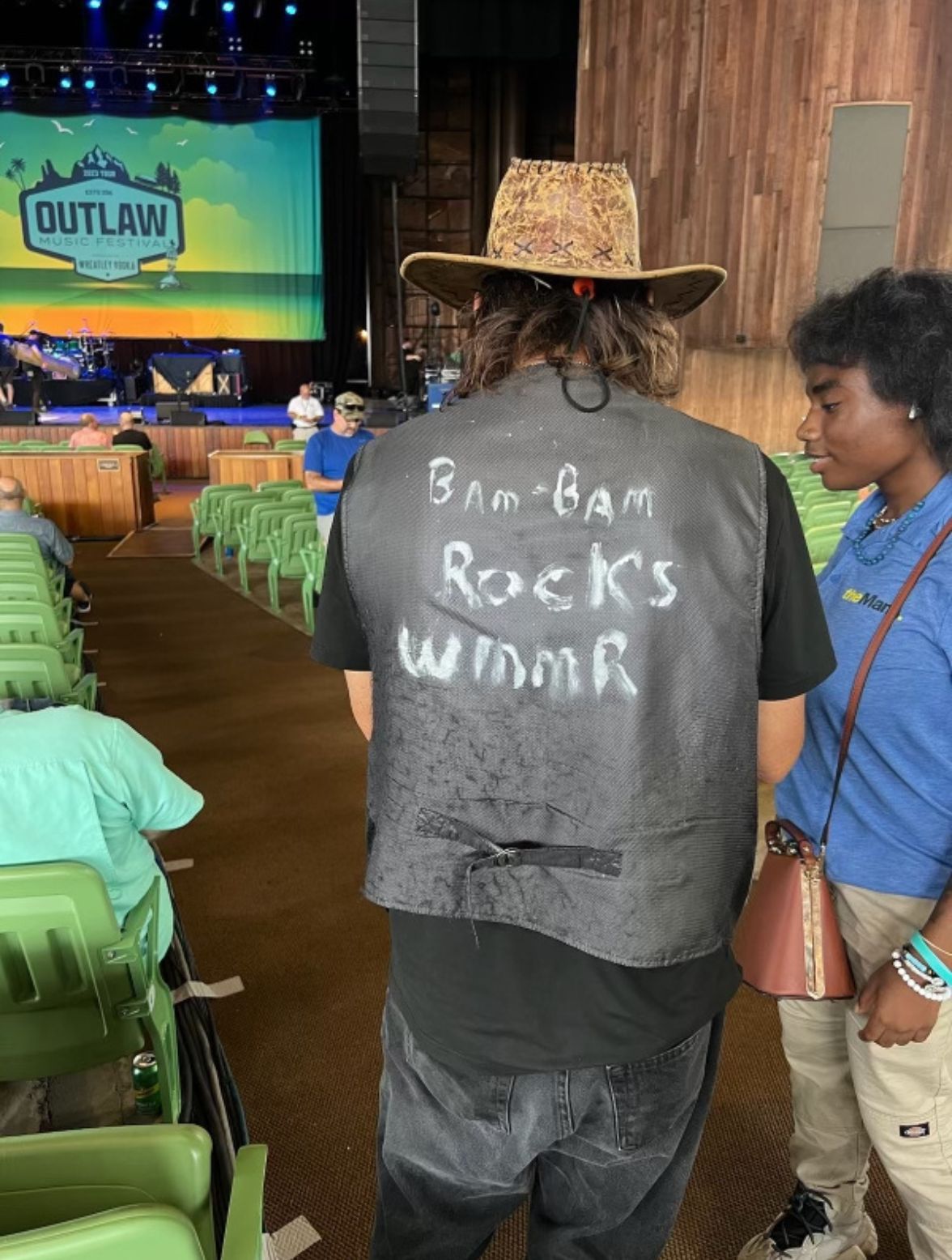 a fan wearing a vest with "BamBam rocks WMMR" handwritten onto it