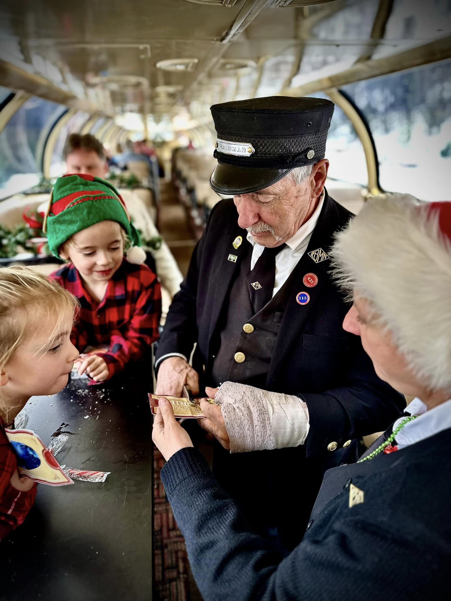 Ticket taker on train ride with kids.