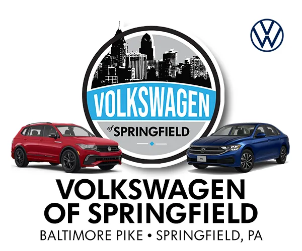 Volkswagen of Springfield logo and artwork featuring a red car and a blue car.