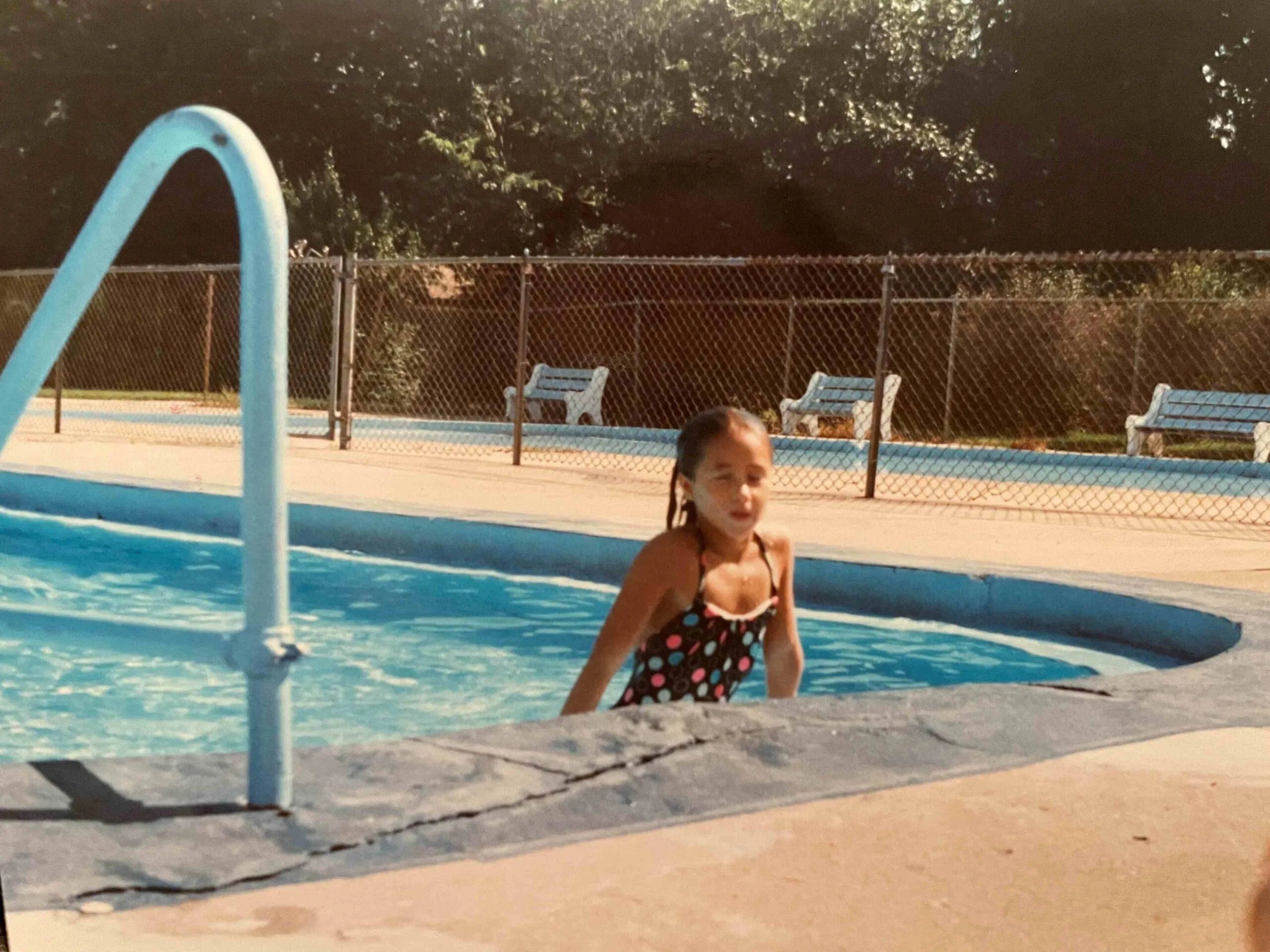 Young Kathy climbing out a pool