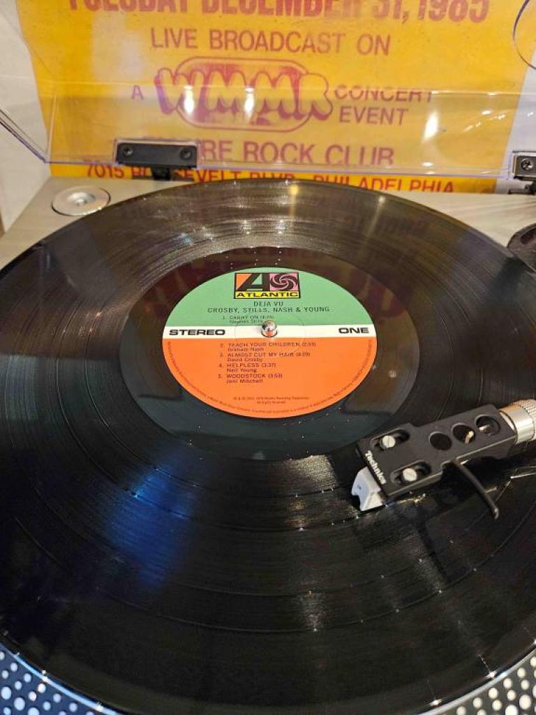 The vinyl record for Crosby, Stills, Nash and Young's "Deja Vu" with the record player needle directly in the center of the record