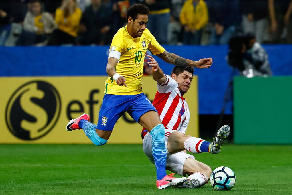 Neymar (L) of Brazil struggles for the ball with Dario Veron of Paraguay during a match between Brazil and Paraguay as part of 2018 FIFA World Cup Russia Qualifier at Arena Corinthians on March 28, 2017 in Sao Paulo, Brazil.