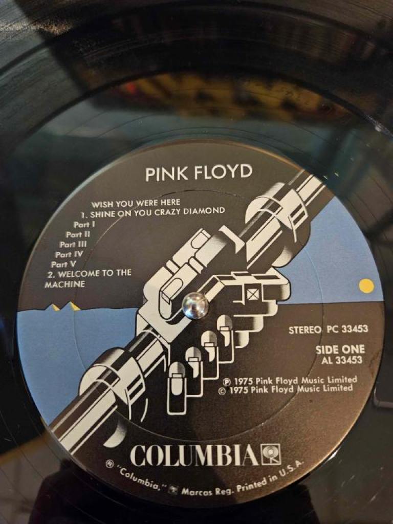 The first side album track list and art from Pink Floyd's "Wish You Were Here" on vinyl