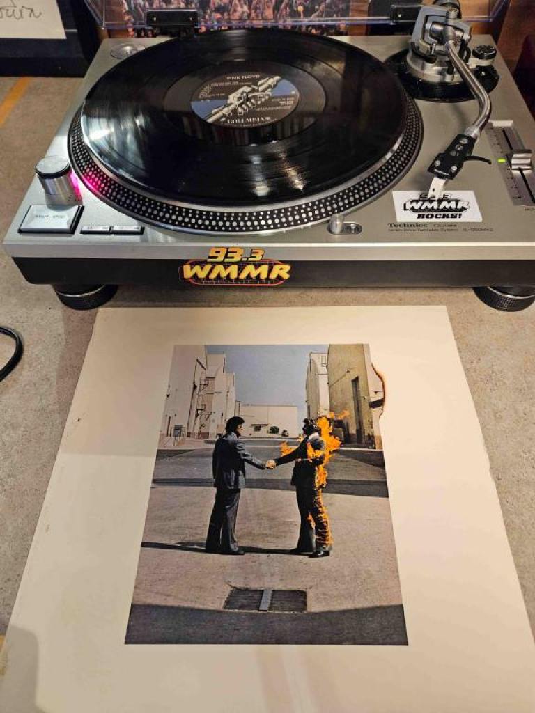 The album art cover and vinyl record of Pink Floyd's "Wish You Were Here" on a turntable